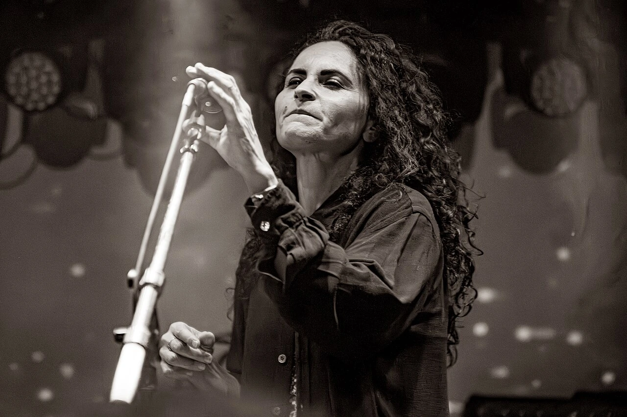 Rain Phoenix performing on stage at a microphone