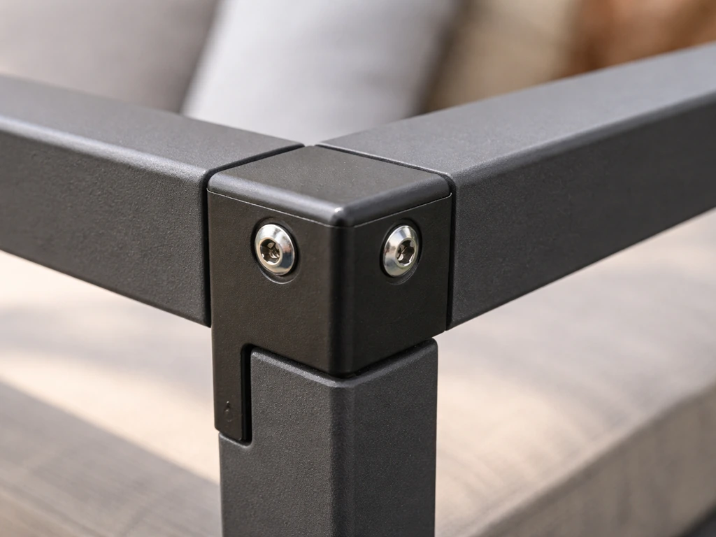 Close-up of a powder-coated aluminum and steel furniture frame joint with visible fasteners