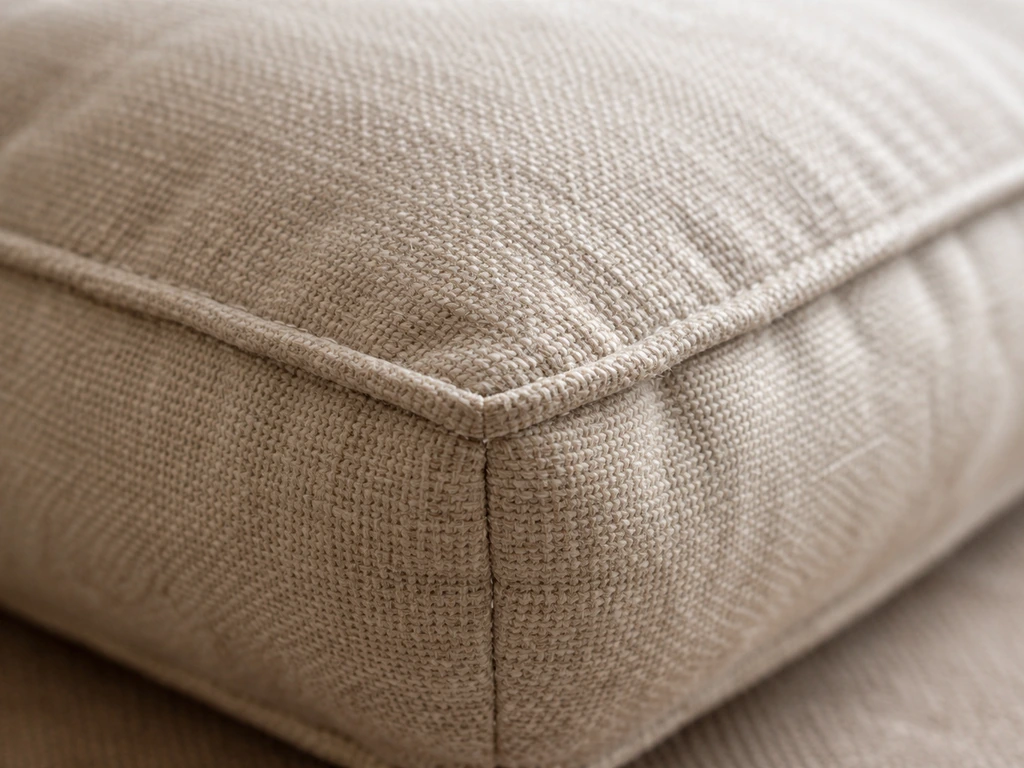 Macro view of cushion fabric weave, foam fill texture, and neat stitching seam details