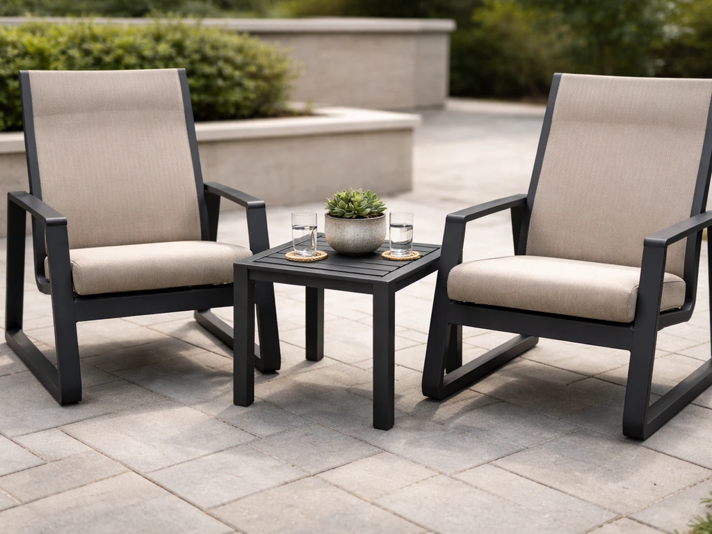Modern Telescope-style sling chairs and chat table on a clean outdoor patio with neutral cushions.