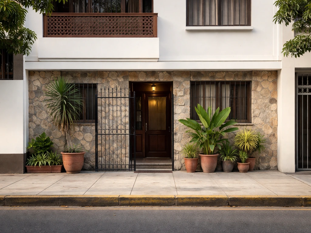 Street-level view of a modest guesthouse facade on Calle Ernesto Diez Canseco in Miraflores, Lima
