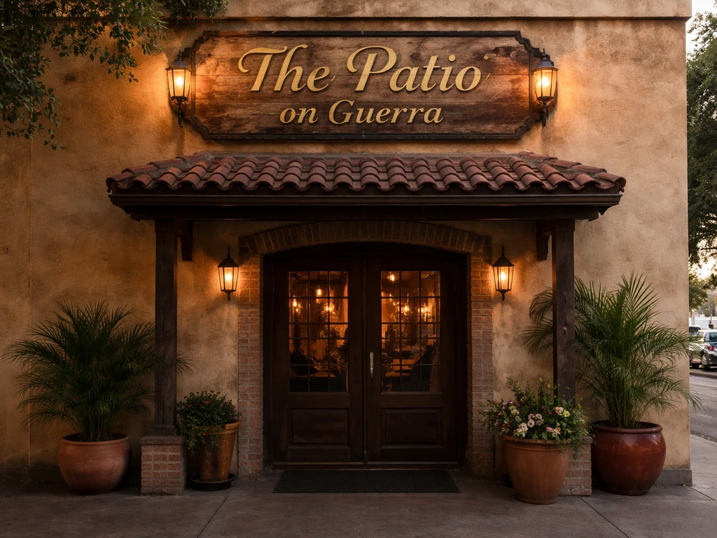 Exterior entrance with a clear sign reading “The Patio on Guerra” above the doorway.