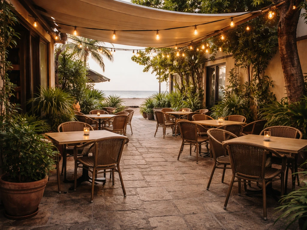 Inviting patio-courtyard with outdoor seating and soft evening light at a beachside cafe