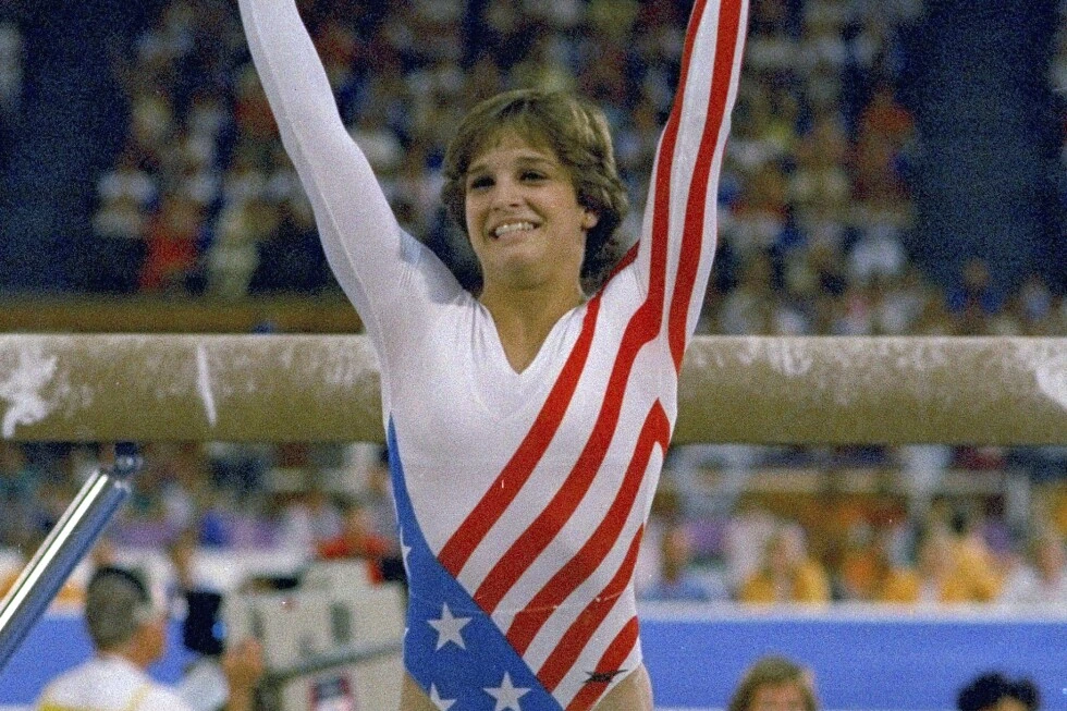 Mary Lou Retton celebrating at a gymnastics competition in a patriotic leotard