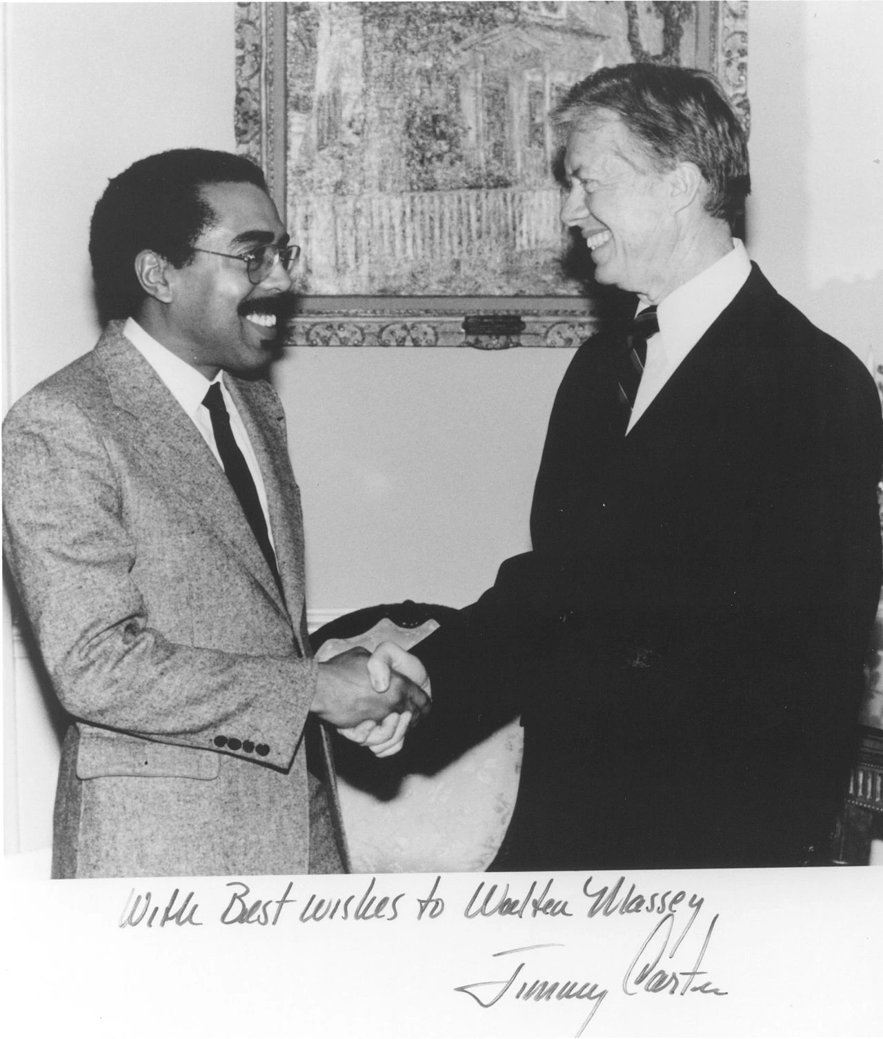 Black-and-white photo of Walter E. Massey shaking hands with Jimmy Carter in an academic or public setting