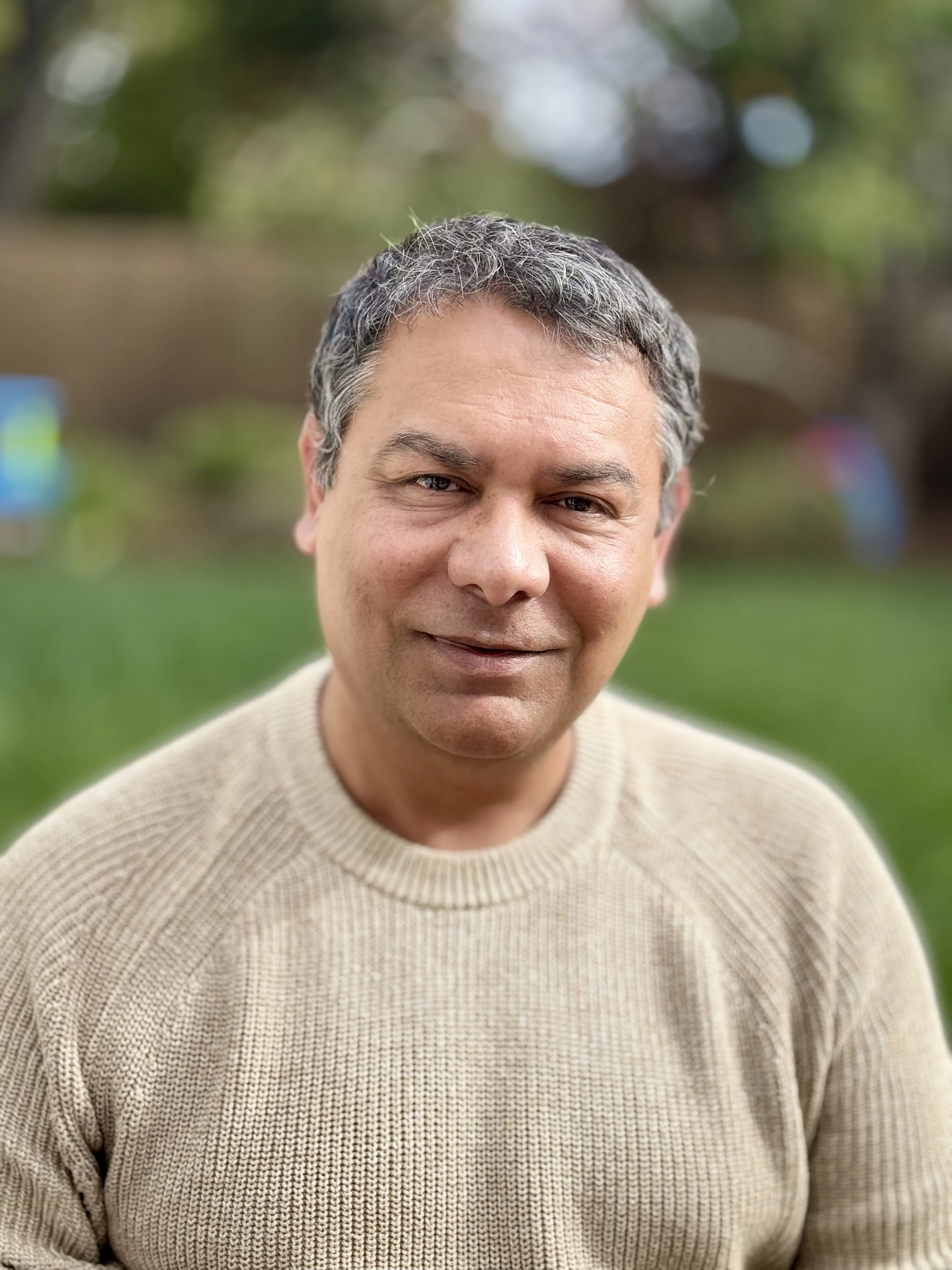 Portrait of Sandeep Swadia outdoors in a beige sweater