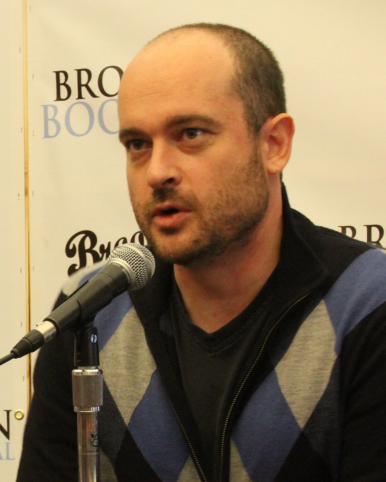 Patrick Somerville speaking at a microphone at the Brooklyn Book Festival