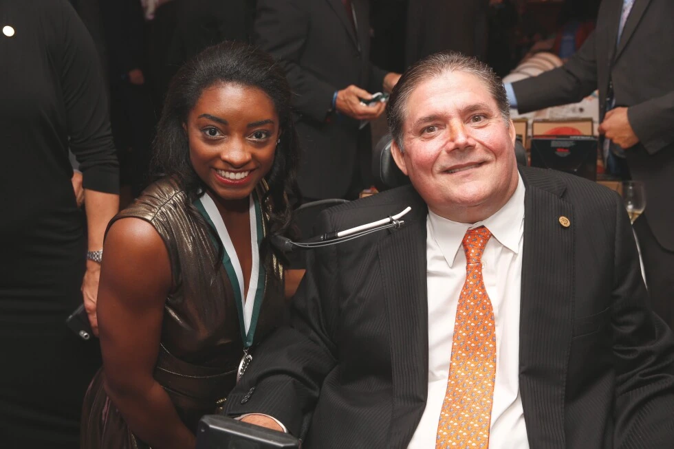 Marc Buoniconti at an event, smiling in a suit and tie