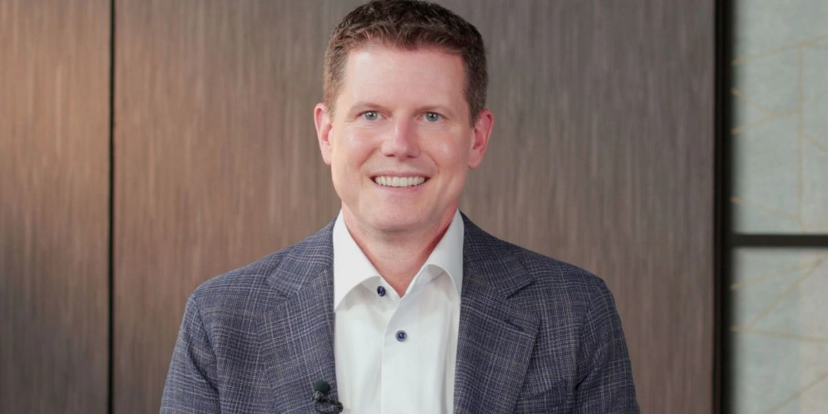 Jason J. Buechel, Whole Foods / Amazon executive, in a portrait photo wearing a blazer and white shirt.