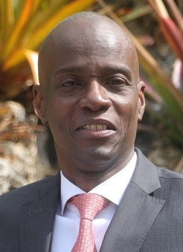 Jovenel Moïse, Haitian president, in a formal portrait outdoors wearing a suit and tie.
