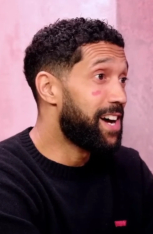 Gaël Clichy in a portrait photo, smiling in profile against a pink background