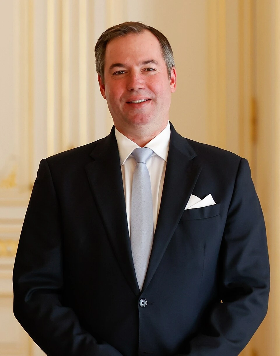 Portrait of Guillaume V, Grand Duke of Luxembourg in a dark suit and tie indoors