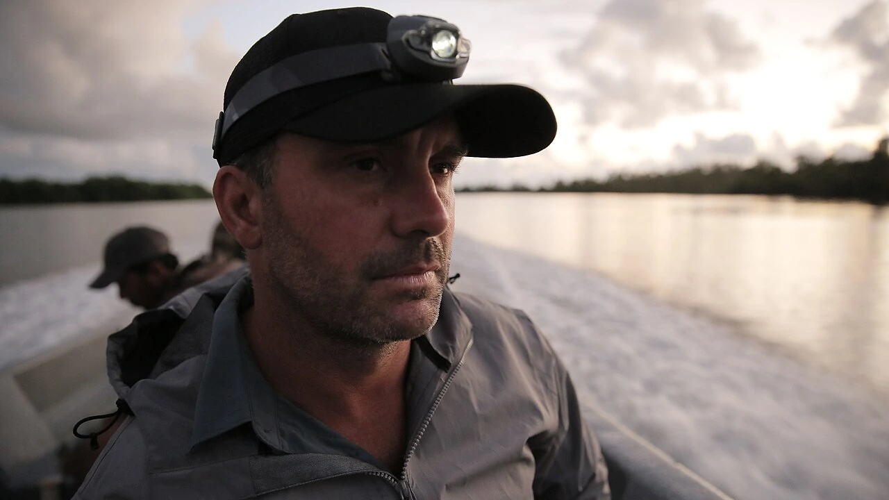 Cyril Chauquet on a boat at sunset wearing a headlamp and cap