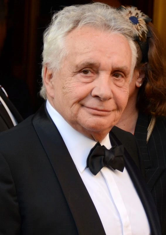 Michel Sardou posing at an event in a tuxedo