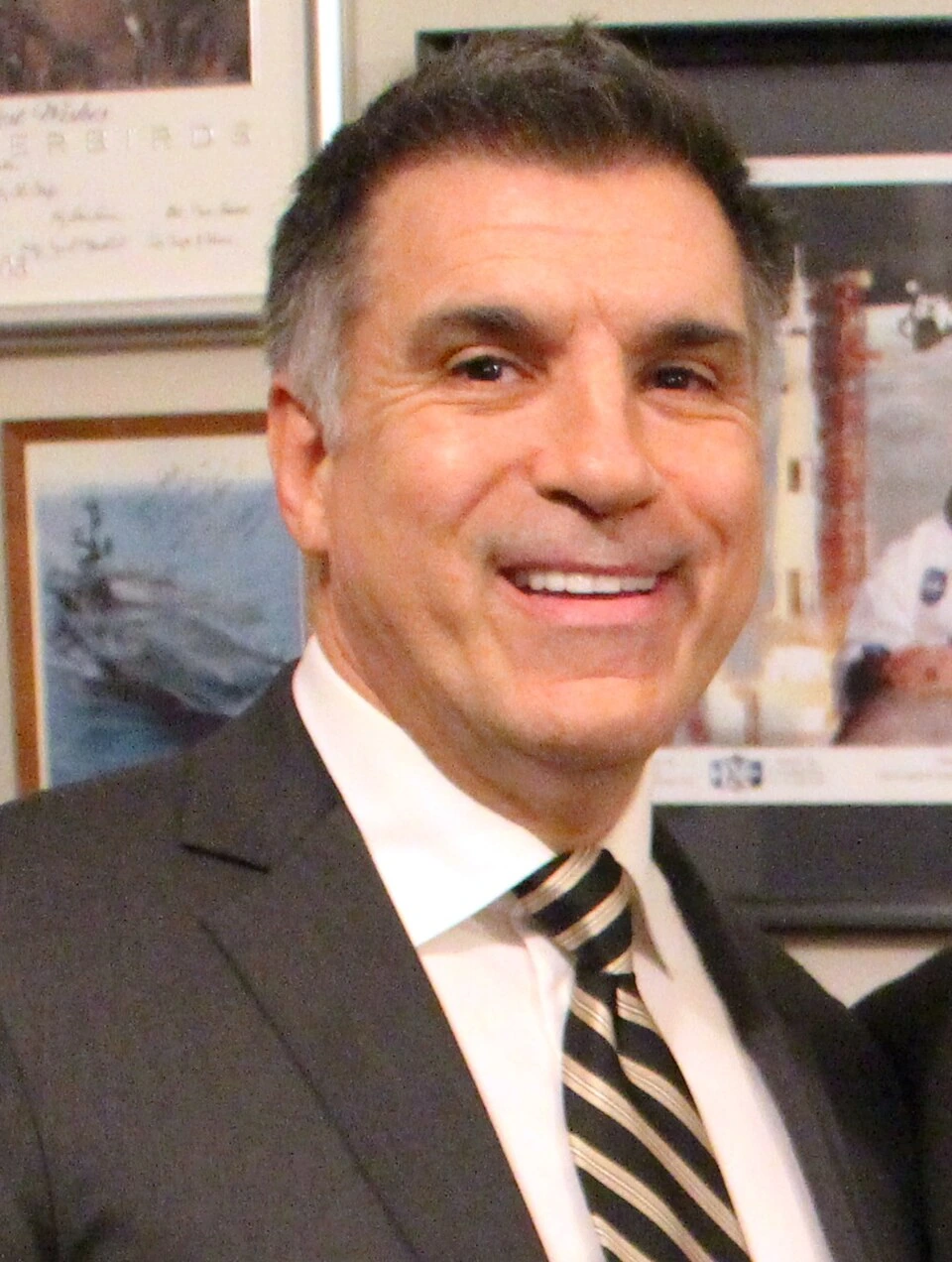Portrait photo of Vincent Viola in a suit and tie, smiling at an indoor event.