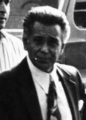 Black-and-white photo of Nicodemo Scarfo standing outdoors in a suit and tie.