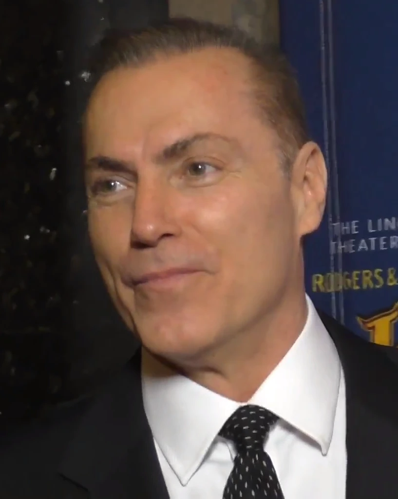 Al Sapienza at an event, wearing a suit and tie