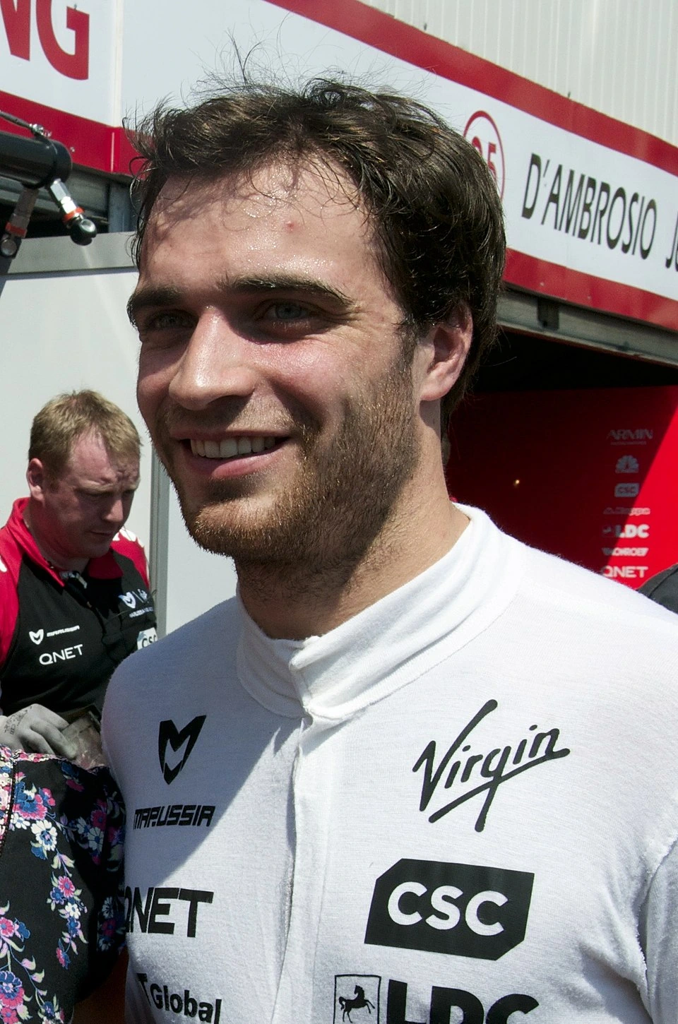 Jerome D’Ambrosio in a racing team setting wearing a white Virgin Racing top