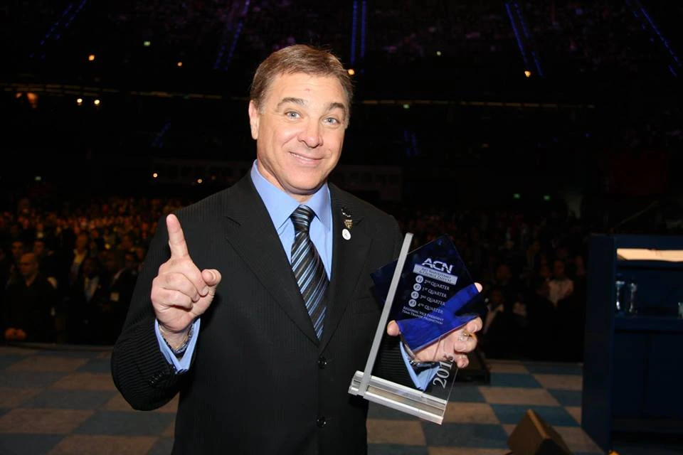 Art Napolitano holding an ACN award at an event