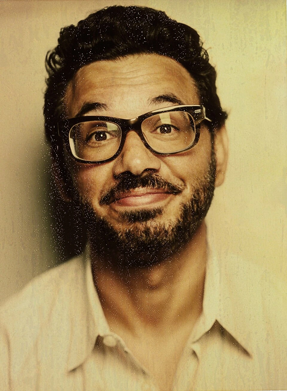 Portrait photo of comedian and actor Al Madrigal wearing glasses and a beige shirt