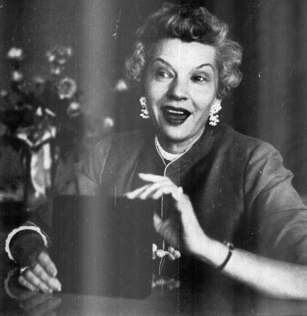 Black-and-white portrait of Brownie Wise speaking or gesturing, likely from a 1954 Business Week cover photo.