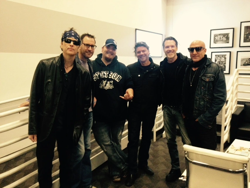 The BoDeans posing together indoors in a candid group photo.
