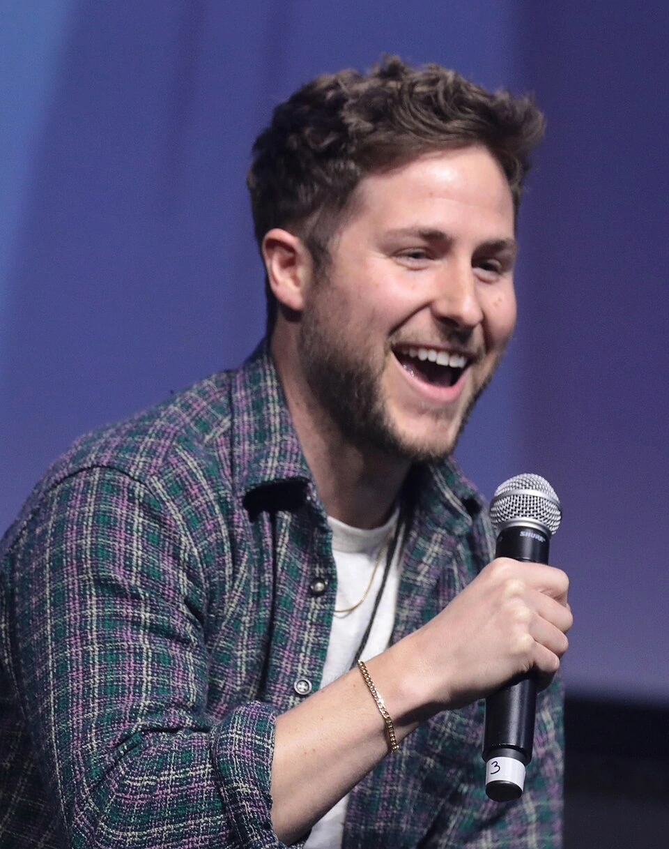 Griffin Benger speaking on stage with a microphone