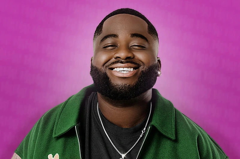 Portrait photo of Bash the Entertainer smiling against a pink background