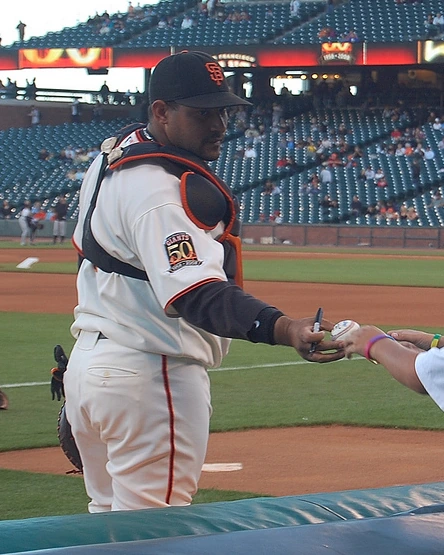Bengie Molina signs autographs at a baseball stadium