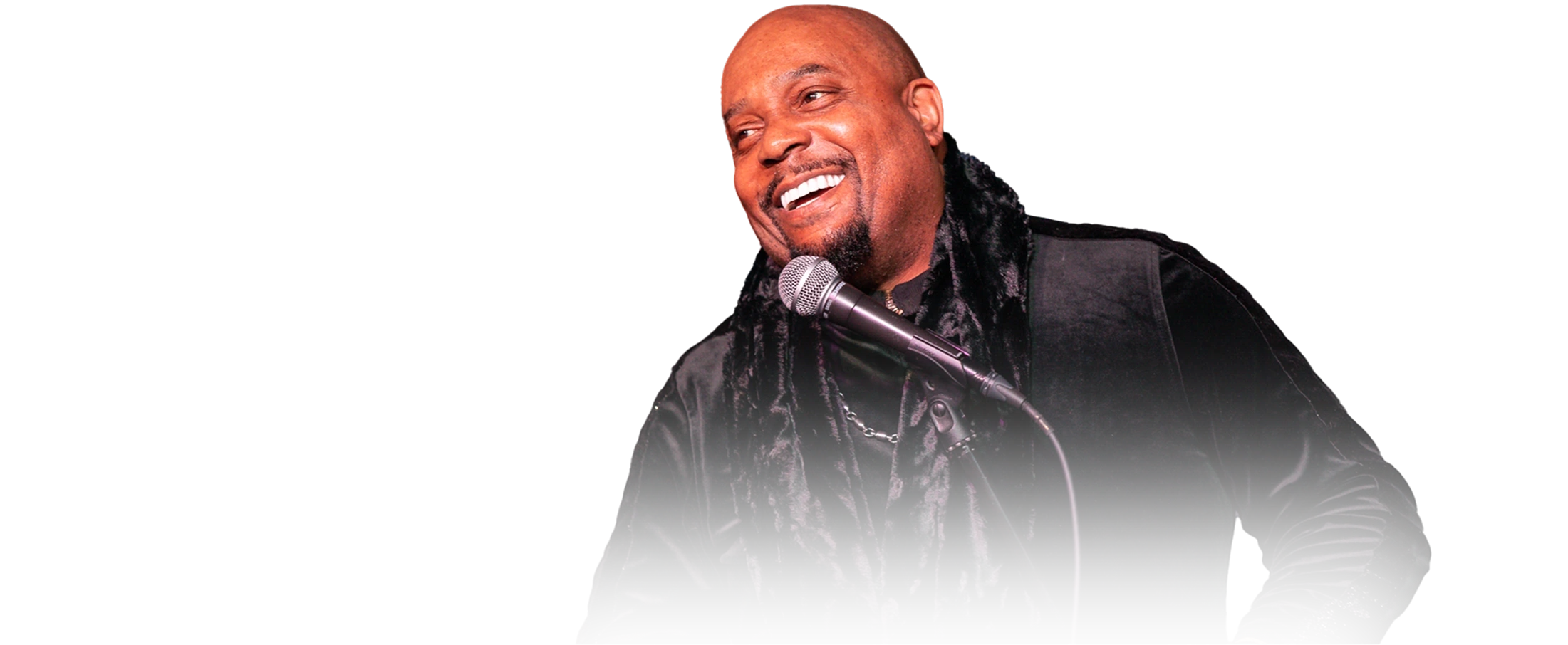 Arnez J performing on stage with a microphone