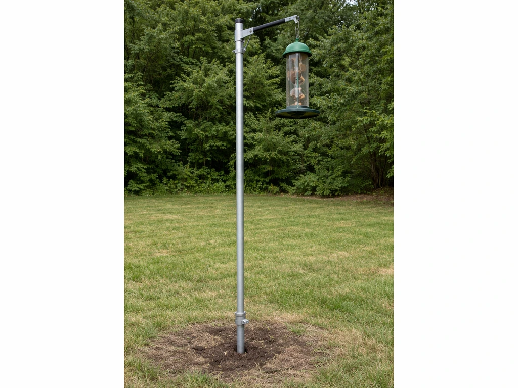 Steel feeder pole setup with EMT conduit anchored in the ground and feeder mounted at the top