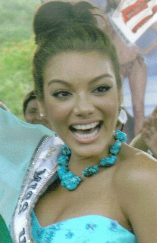 Zuleyka Rivera smiling in a turquoise dress and necklace