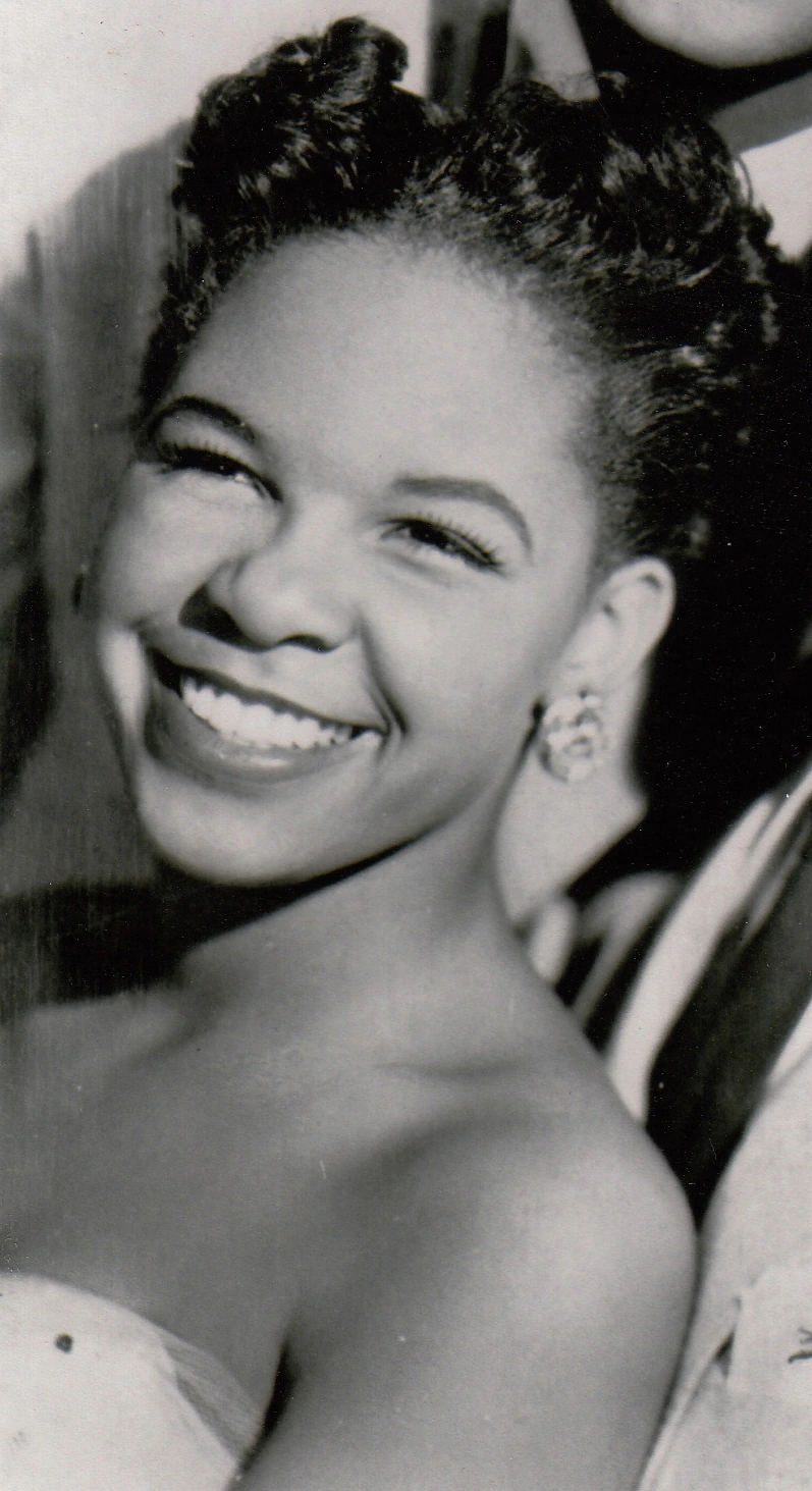 Zola Taylor smiling in a black-and-white portrait photo.
