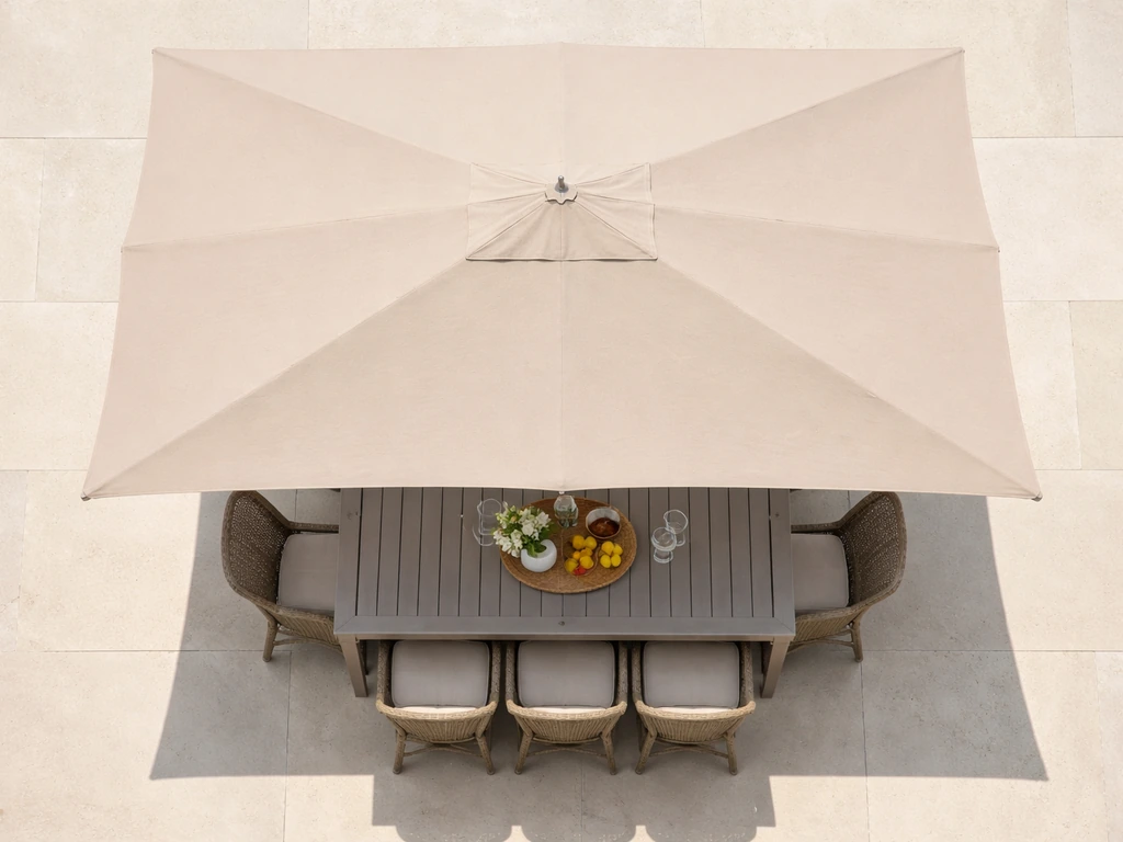 Top-down view of a patio table with an umbrella canopy extending about 2 feet beyond all sides.