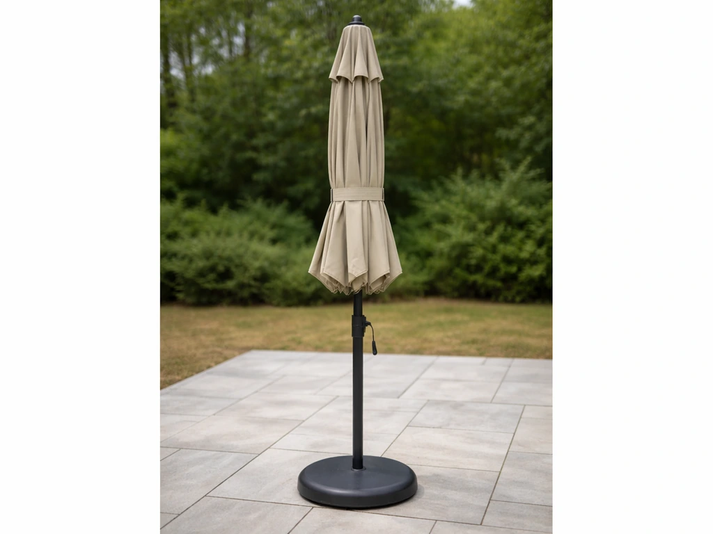 Closed patio umbrella secured for troubleshooting, crank pole stable on a quiet outdoor patio.