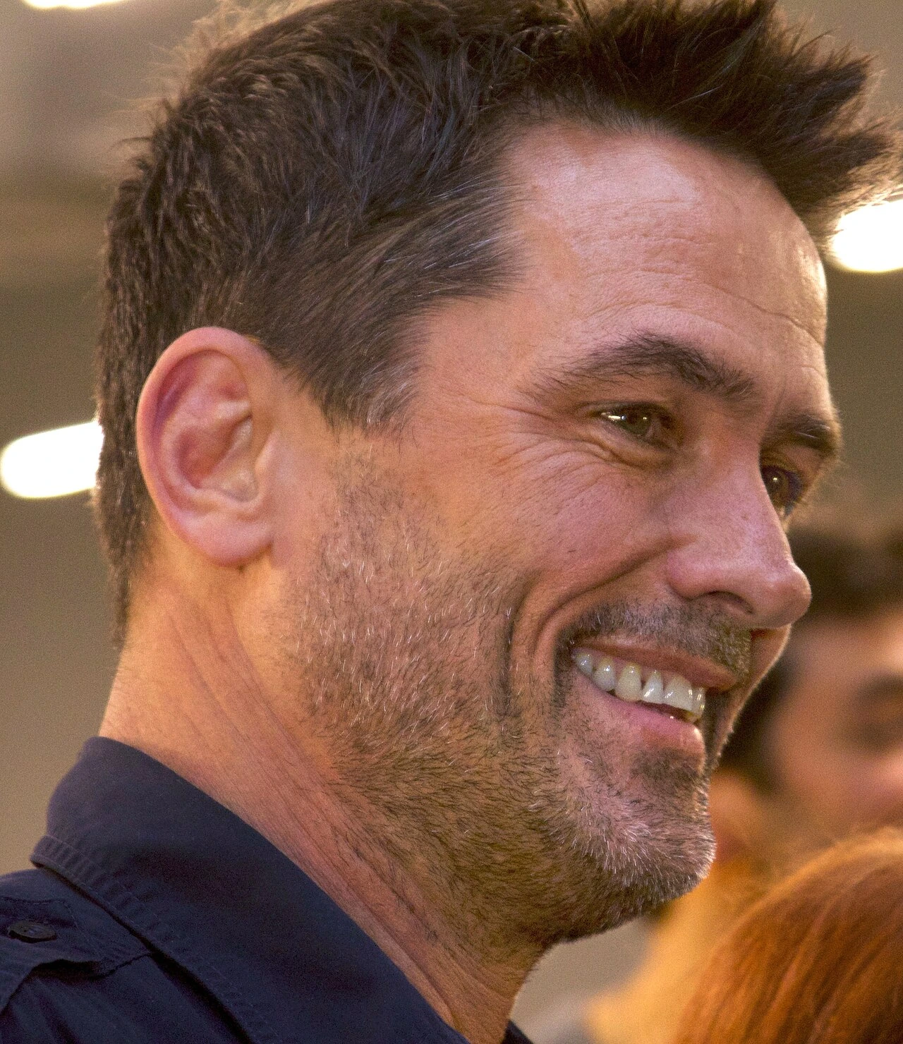 Billy Campbell at an event, smiling in profile.