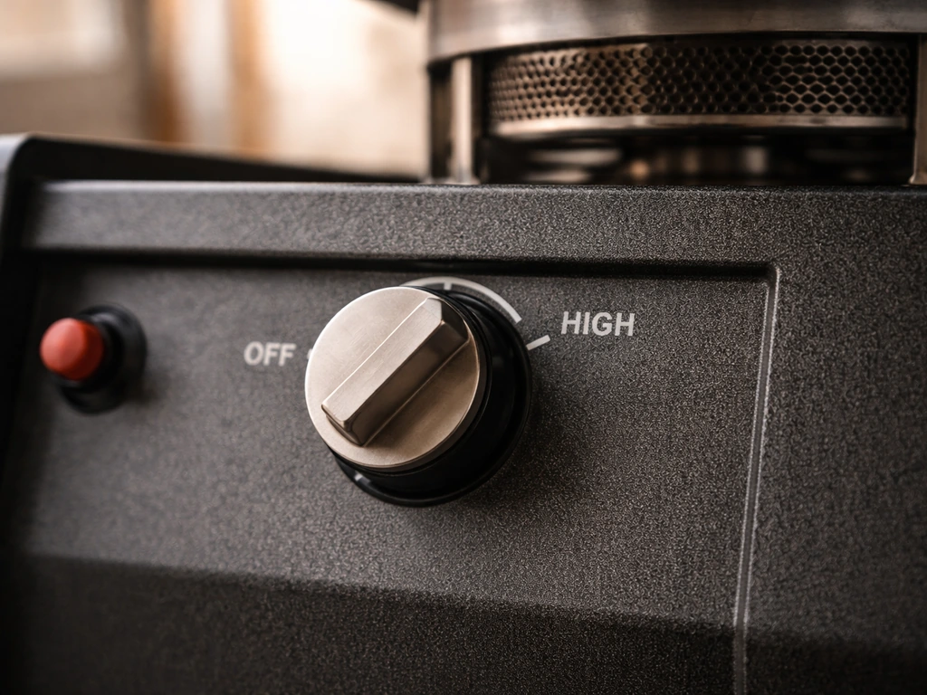 Close-up of a heater control knob on OFF/HIGH with a burner head nearby, suggesting troubleshooting for lighting issues.