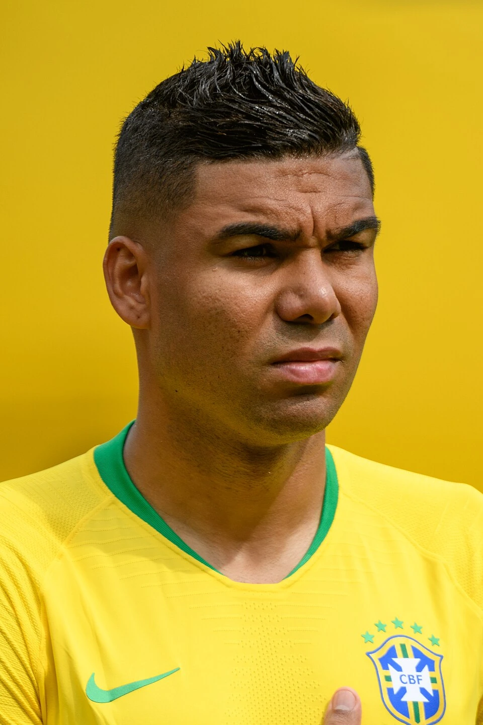 Casemiro in Brazil national team kit, close-up portrait against a yellow background