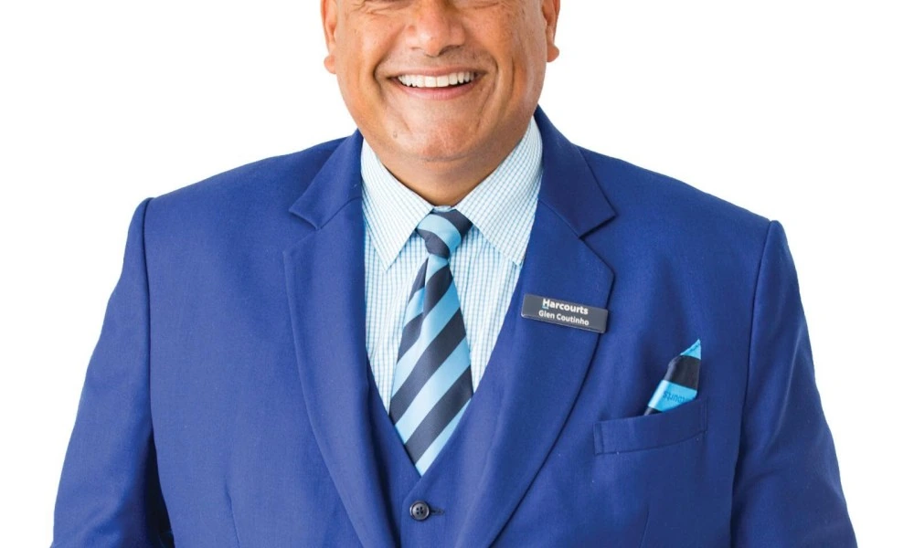 Portrait of Glen Coutinho in a blue suit