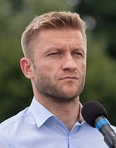 Jakub Błaszczykowski speaking at an outdoor event