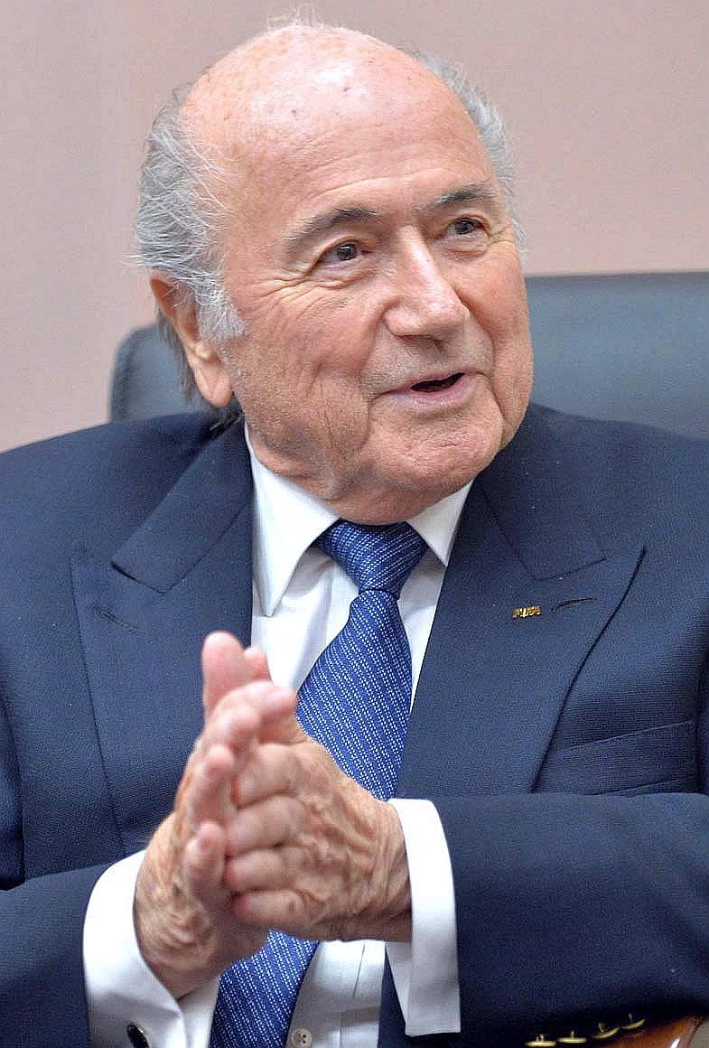 Joseph Blatter in a suit and tie, seated and clapping, portrait photo