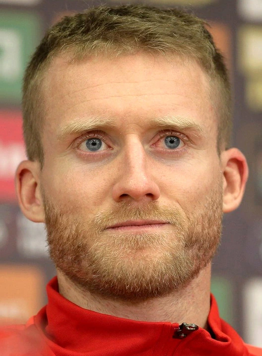 André Schürrle, German footballer, in a close-up portrait wearing a red jacket