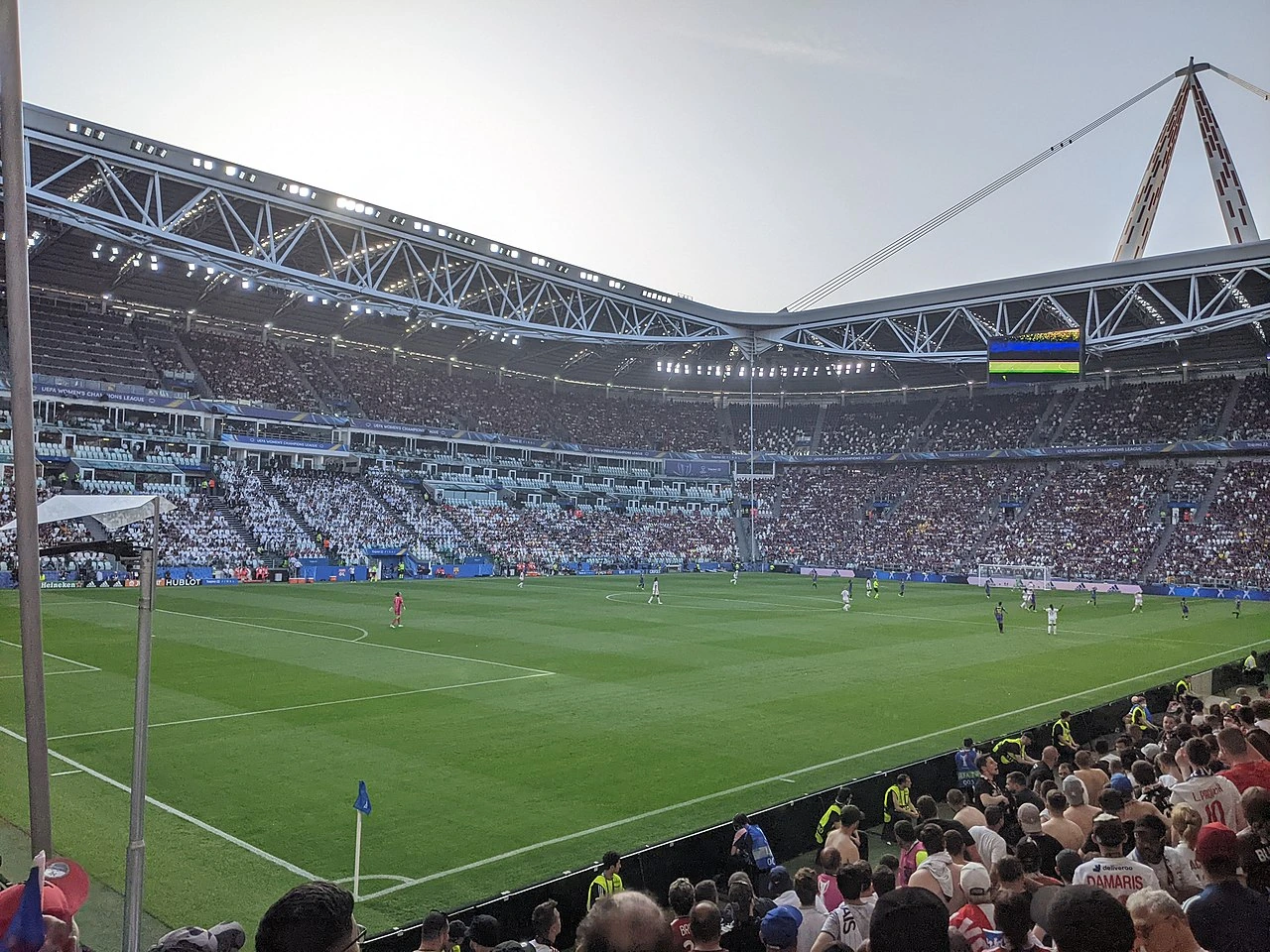 A wide view inside Juventus Stadium in Turin, showing the pitch, stands, and stadium roof structure during a match.