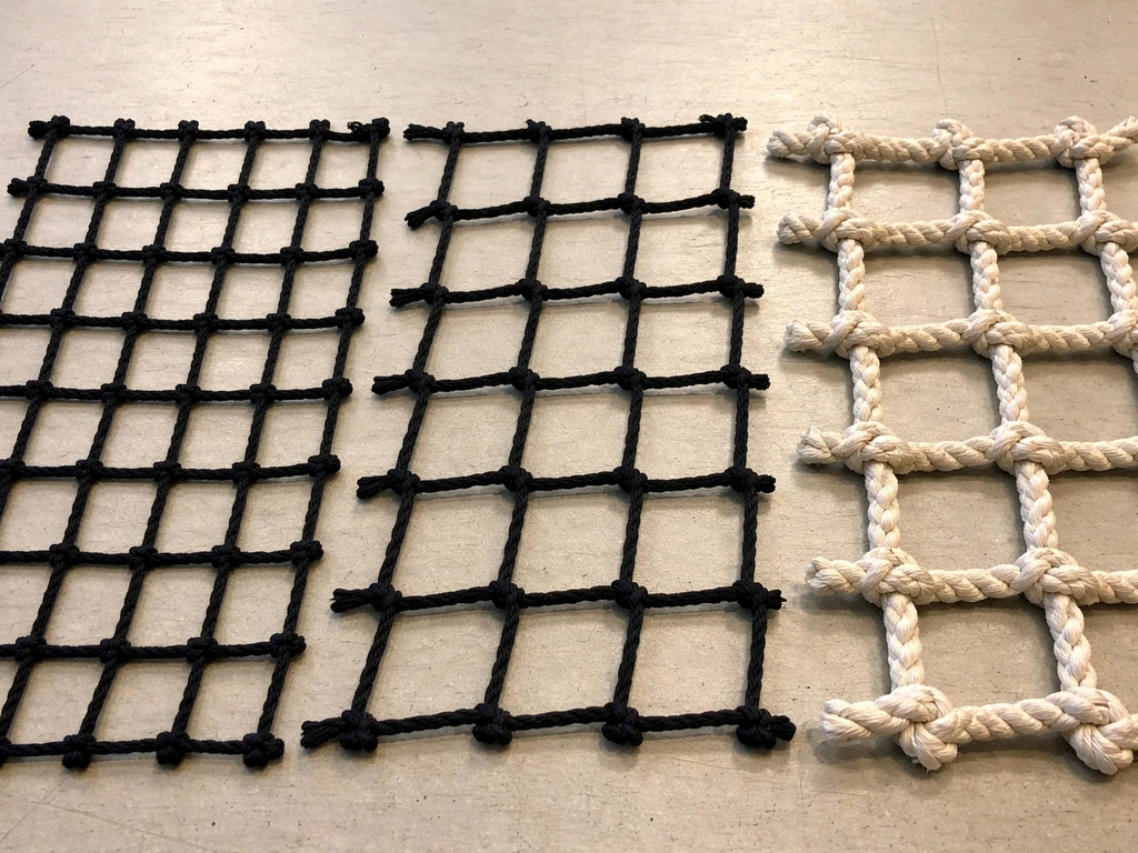 Close-up of three netting samples with different mesh and material types on a simple workbench.