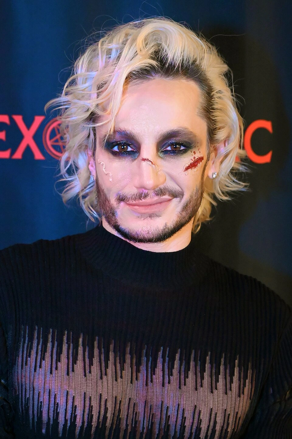 Frankie Grande at an event, close-up portrait with blonde hair and dramatic makeup