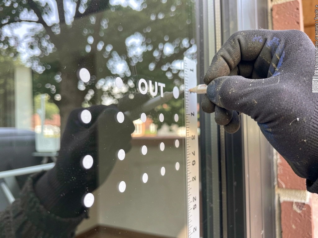Blinds closed and houseplants moved back from the window to reduce collisions.