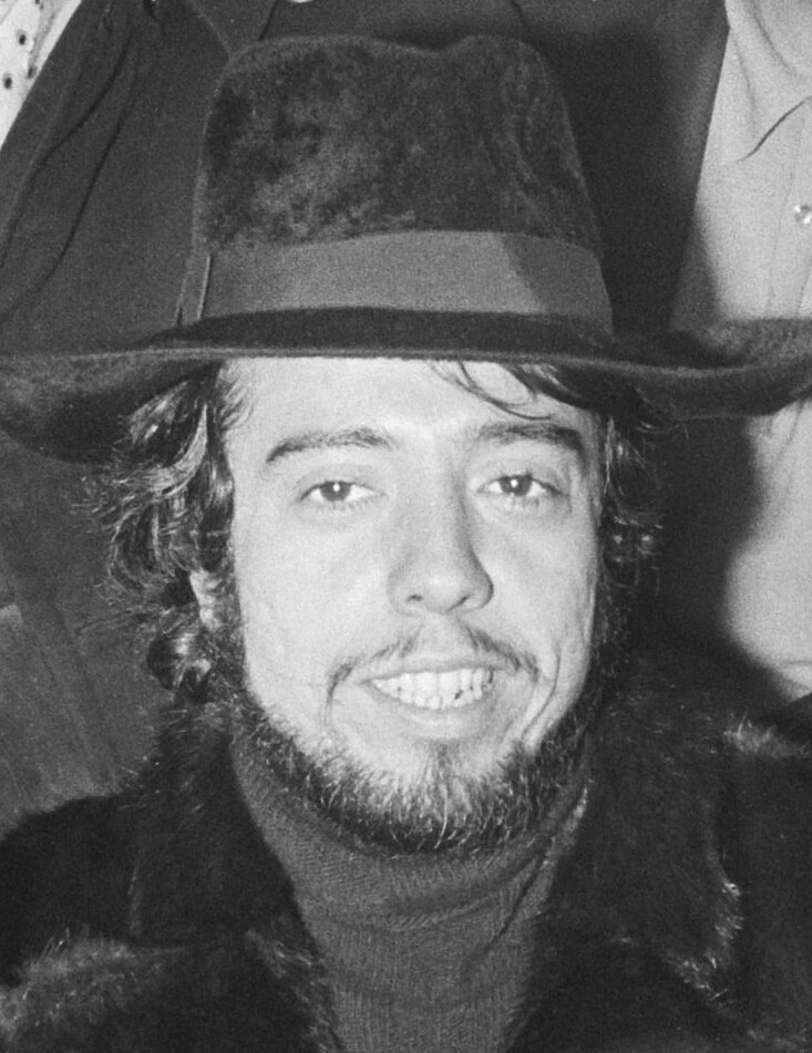 Black-and-white portrait photo of Sergio Mendes wearing a hat
