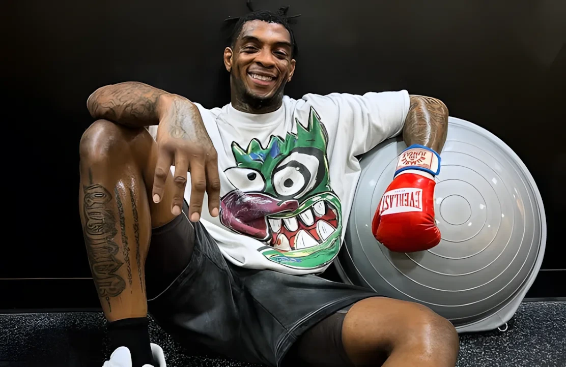 Sedriques Dumas seated in training gear with boxing gloves