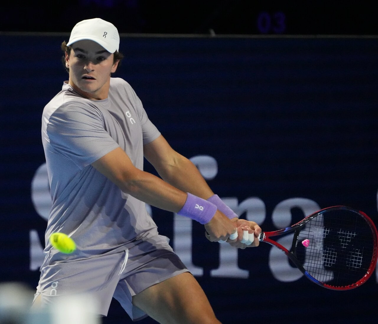 João Fonseca in action at a tennis match, holding a racket during play.