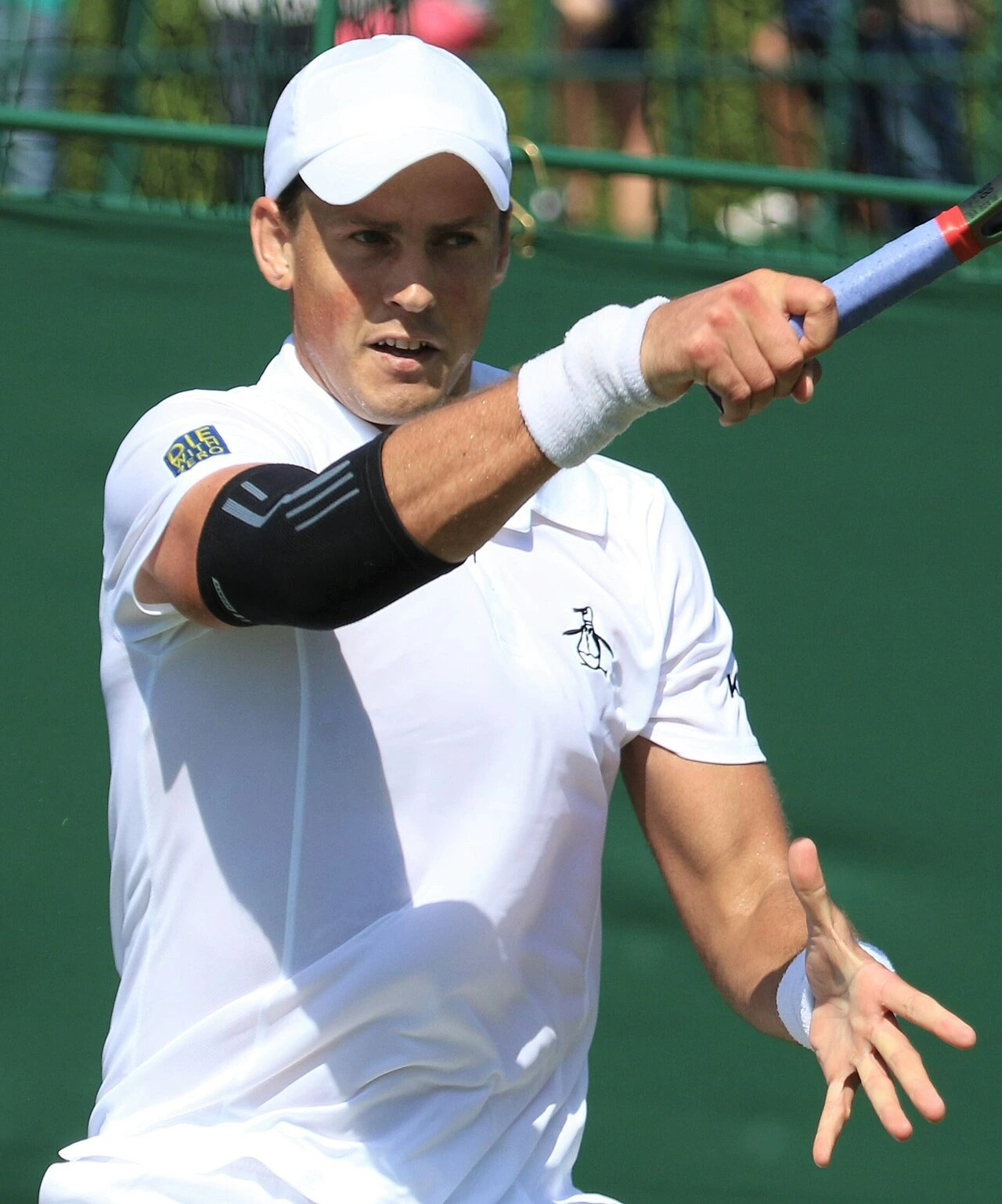 Vasek Pospisil during a tennis match in white kit